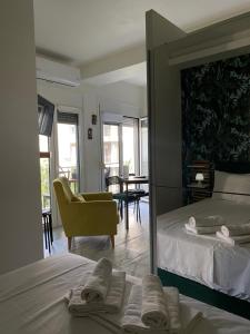 a bedroom with a mirror and a bed and a chair at ΑΘΗΝΑ HOME in Ioannina