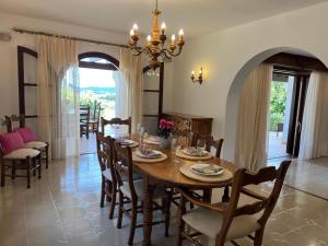 a dining room with a wooden table and chairs at Villa Marlis Ibiza in IBZ
