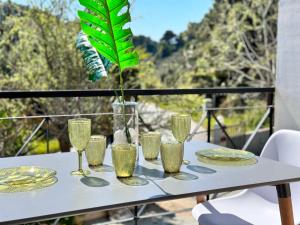 a table with glasses and plates on a balcony at Villa Diamanti in Kolios