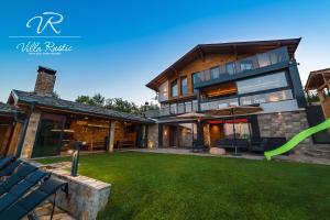 a large house with a lawn in front of it at Вила Рустик / Villa Rustic in Kyustendil