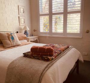 a bed with two pillows on it in a bedroom at The Old Butter Factory at Springhurst Estate in Springhurst