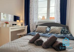 a bed with two pillows on it in a bedroom at Paris Room Old Town Gdansk in Gdańsk