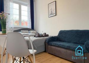 a living room with a couch and a table at Paris Room Old Town Gdansk in Gdańsk