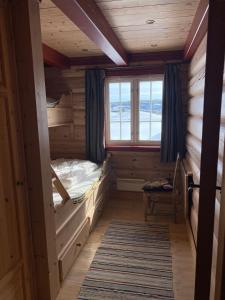 a room with two bunk beds and a window at Kvenahytta in Markegardlian +20 photos