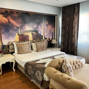 a bedroom with a large bed with a painting on the wall at Elite Marmara Bosphorus & Suites in Istanbul