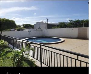 a swimming pool on top of a building with a fence at Apartamento aconchegante in Teresina
