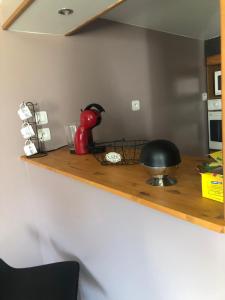 a kitchen counter top with a red appliance on it at Maison de campagne in Hamelet