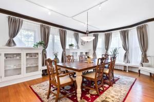 a dining room with a wooden table and chairs at - King Bed - Massive Yard - Fully Equipped Condo in Geneva