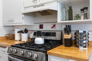 a kitchen with a stove top oven in a kitchen at - King Bed - Massive Yard - Fully Equipped Condo in Geneva +22 photos
