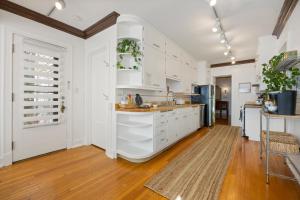 a kitchen with white cabinets and a counter top at - King Bed - Massive Yard - Fully Equipped Condo in Geneva