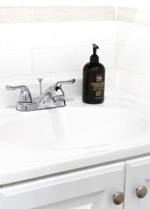 a bathroom sink with a bottle of soap on it at Relaxx - 3Brighton Beach - Green3057 in Brooklyn