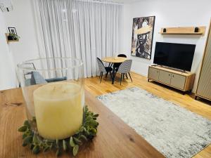 a candle sitting on a table in a living room at MGA Apartment in Bucharest