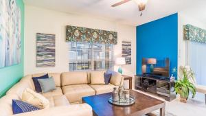 a living room with a couch and a tv at BRL4805 in Orange Park