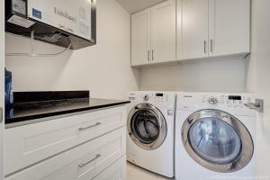 a white laundry room with a washer and dryer at Quiet Suites Up to 8 Guests Near DTVan Monthly Option in West Vancouver