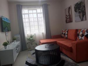 a living room with a couch and a table at Maggies suites and Bnb in Nairobi