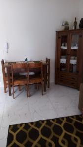 a living room with a table and a cabinet at Apto Tijucas lá vie in Tijucas