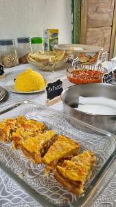 a glass plate with some food on a table at Abrigo de Montanha Xique Xique in Igatu +38 photos
