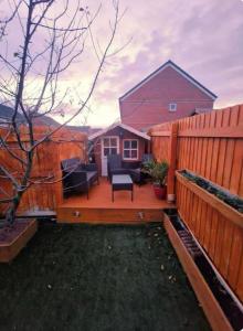una terraza de madera con una valla frente a una casa en 1 minute walk to Liverpool Stadium Free Private Parking, Anfield Liverpool Entire House, en Liverpool