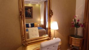 a bedroom with a bed and a mirror on the wall at BP Apartments Budapest in Budapest