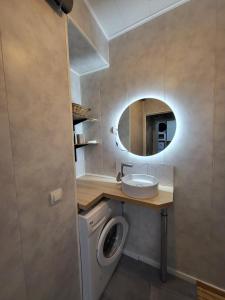a bathroom with a sink and a washing machine at Maison 4p, parking, terrasse, jardin in Chancenay +58 photos