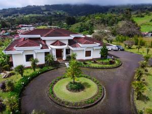 an aerial view of a house with a driveway at Hotel Poas Paradise in Alajuela