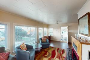 a living room with two chairs and a table at Whale - Watcher's Perch in Depoe Bay