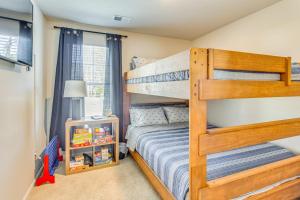 a bedroom with a bunk bed with a ladder at Near Golf Courses Cozy Home in Ocean Isle Beach! in Ocean Isle Beach