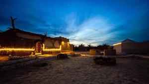 a building with lights in front of it at night at Siwa Serenity Home in Siwa