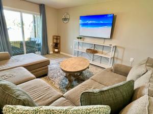 a living room with a couch and a flat screen tv at Bayou 565 - Panhandle Paradise in Marietta