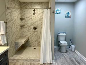 a bathroom with a shower and a toilet at Bayou 565 - Panhandle Paradise in Marietta +31 photos