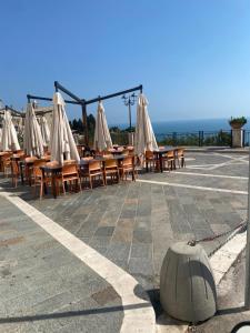 a row of tables and chairs with umbrellas at Little house in Vasto