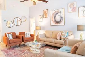 a living room with a couch and chairs and a table at Super Mario Hideaway - Pool, Spa, Game Room Fun! in Davenport