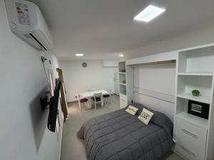 a small bedroom with a bed and a desk at Torre Santana in San Luis