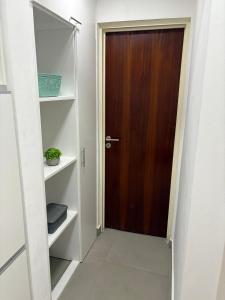 a brown door in a white room with shelves at Torre Santana in San Luis