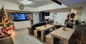 a living room with a christmas tree and tables at Pension Mediterrano - Monteurzimmer in Bedburg