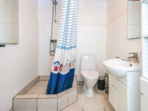 a bathroom with a toilet and a shower curtain at 5 person holiday home in Sydals in Trænge +32 photos