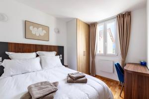 una camera con letto, scrivania e finestra di Jolie Maison 3 à 6 pers - 35 min de Paris centre a Romainville