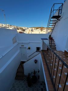 a view of a stairway with stairs and a blue sky at CasaElbarranko in Arcos de la Frontera +57 photos