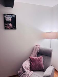 a living room with a couch and a picture on the wall at Dom na Styku in Jaworzynka