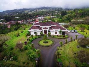 an aerial view of a house on a hill at Hotel Poas Paradise in Alajuela