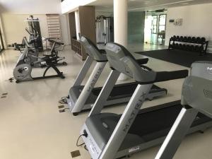 a gym with treadmills and elliptical machines at Flat Muro Alto Ecolife in Porto De Galinhas
