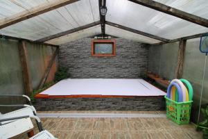 a room with a mattress in a brick wall at Habitación cocina y Quincho con Piscina temperada in Lenca +16 photos
