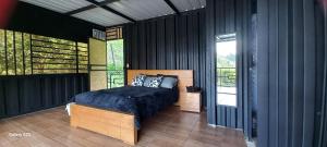 a bedroom with a bed and a balcony at Cabañas Ecologe BLESS in Chiquinquirá +81 photos