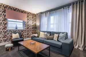 a living room with a couch and a table at Ness Central in Inverness
