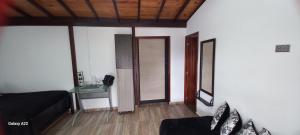 a living room with a couch and a table at Cabañas Ecologe BLESS in Chiquinquirá