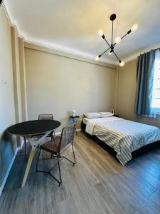 a bedroom with a bed and a table and a table and chairs at Hermoso Studio a metros del Obelisco in Buenos Aires