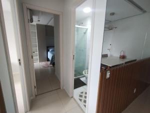 a bathroom with a walk in shower and a glass door at Paz e lazer ao lado do Shoping da ilha in São Luís +28 photos