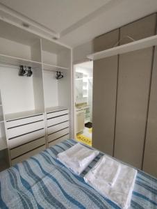 a bedroom with a bed with two towels on it at Paz e lazer ao lado do Shoping da ilha in São Luís