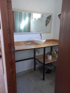a bathroom with a sink and a mirror at El Vagon in San Martín de los Andes