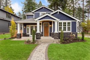 a blue house with a front door and grass at Havenly Homes DMV in Arlington